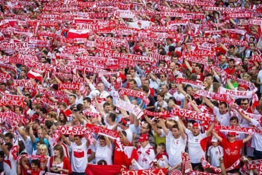 Polish football fans cheers their team in the Warsaw Fanzone