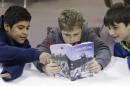 In this Tuesday, Feb. 4, 2014 photo, from left, Erick Izquierdo, Josiah Spear, 12, and Cole McSorley, 12, look at a Trail Life handbook during a gathering of members in North Richland Hills, Texas. Trail Life USA says it has established units in more than 40 states, mostly from Boy Scouts and parents who feel the century-old organization has lost its way. (AP Photo/LM Otero)