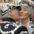 Phyllis Broadbent, the Pearly Queen of Islington, kisses her Pearly King, Jim Broadbent, Pearly King of Islington, outside the Carpenters Arms pub in east London