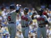 Atlanta Braves' Dan Uggla, center, is congratulated by teammates Freddie Freeman, left, and Justin Upton after hitting a three-run home run during the third inning of a baseball game against the Atlanta Braves, Sunday, June 9, 2013, in Los Angeles. (AP Photo/Mark J. Terrill)