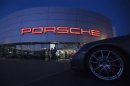 Illuminated Porsche logo is pictured on building of a Porsche retail centre in Niederwangen