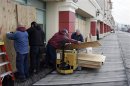 A crew from the Tropicana Casino removes plywood sheets from windows in the aftermath of Hurricane Sandy in Atlantic City