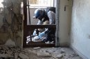 A UN arms expert collects samples during an inspection of a site in Damascus' eastern Ghouta suburb on August 29, 2013