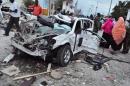 A destroyed car near the damaged Jazeera Palace hotel in Mogadishu on July 26, 2015 following a suicide attack by Shebab insurgents