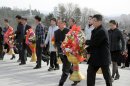 North Koreans carry flowers to giant statues of North Korean late leaders Kim Il Sung and Kim Jong Il at Mansu Hill in Pyongyang, North Korea, Monday, April 15, 2013. North Korea celebrated Monday the 101st birth anniversary of national founder Kim Il Sung, its most important holiday of the year. (AP Photo/Kyodo News) JAPAN OUT, MANDATORY CREDIT, NO LICENSING IN CHINA, HONG KONG, JAPAN, SOUTH KOREA AND FRANCE