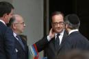 French President Hollande speaks with France's Chief Rabbi Haim Korsia, Interior Minister Cazeneuve and Prime Minister Valls after a meeting with the French President and representatives of religious communities at the Elysee Palace in Paris