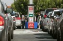 Costco members fill up with discounted gasoline at a Costco gas station in Van Nuys, Calif., Friday, Oct. 5, 2012. Californians woke up to a shock Friday as overnight gasoline prices jumped by as much as 20 cents a gallon in some areas, ending a week of soaring costs that saw some stations close and others charge record prices. (AP Photo/Damian Dovarganes)
