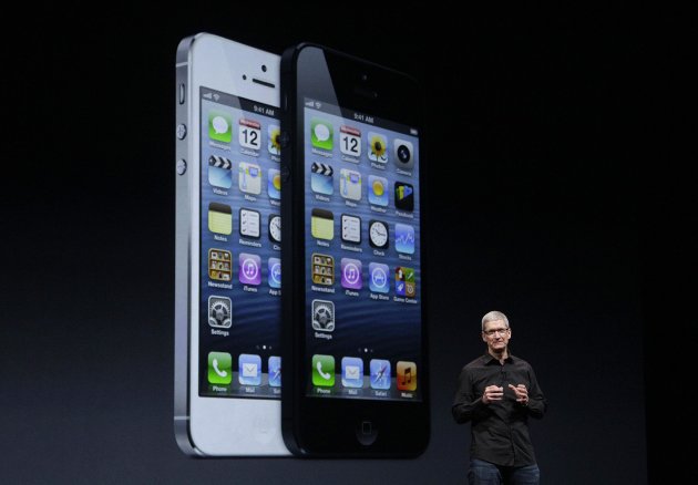 Apple CEO Tim Cook speaks in front of an image of the iPhone 5 during an Apple event in San Francisco, Wednesday, Sept. 12, 2012. (AP Photo/Jeff Chiu)