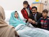 In this undated handout photo issued by Queen Elizabeth Hospital, in Birmingham, England, on Friday, Oct. 26, 2012, Malala Yousufzai in her hospital bed, poses for a photograph, with her father Ziauddin, second right accompanied by her two younger brothers Atal, right and Khushal, centre. The father of a 15-year-old Pakistani girl shot in the head by the Taliban described his daughter’s survival and recovery as miraculous Friday, calling her shooting a turning point for Pakistan.  Malala Yousufzai is recovering at the Queen Elizabeth Hospital in Birmingham, where she was flown for treatment and protection from Taliban threats after she was shot on Oct. 9 in northwestern Pakistan. Her father, Ziauddin, flew to the U.K. to be by her side. (AP Photo/ Queen Elizabeth Hospital Birmingham)