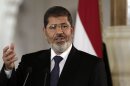 FILE - In this July 13, 2012 file photo, Egyptian President Mohammed Morsi speaks to reporters at the Presidential palace in Cairo. Egypt's army has held Morsi incommunicado at undisclosed locations since pushing him from power in a July 3 coup. But the country's military-backed interim leadership is coming under increasing international criticism about Morsi's continued detention, and allowing two visits in quick succession appeared to be an attempt to ease at least some of the pressure on the new administration. (AP Photo/Maya Alleruzzo, File)