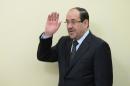 Iraqi Prime Minister Nouri al-Maliki waves as he arrives for an agreement signing with Indian Prime Minister Manmohan Singh in New Delhi on August 23, 2013