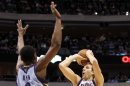 Dallas Mavericks' Nowitzki shoots as Memphis Grizzlies' Allen blocks during their NBA basketball game in Dallas