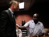 South African 'Blade Runner' Oscar Pistorius is escorted by police during his court appearance in Pretoria