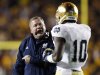 Notre Dame head coach Brian Kelly talks with wide receiver DaVaris Daniels during the first half of an NCAA college football game against Boston College in Boston Saturday, Nov. 10, 2012. (AP Photo/Winslow Townson)