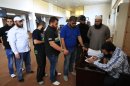Lebanese Sunni Muslim men queue as they register their names for jihad in Syria, at a mosque in the southern port city of Sidon, Lebanon, Tuesday, April 23, 2013. Lebanese Sunni Muslim clerics Ahmad Al-Assir and Sheikh Salem al-Rafie called late Monday for jihad in Syria to protect Sunnis in villages under attack by Syrian troops and pro-government Shiite gunmen. Lebanon and Syria share a complex web of political and sectarian ties and rivalries which are easily enflamed. Lebanon, a country plagued by decades of strife, has been on edge since the uprising in Syria against President Bashar Assad began in March 2011, with deadly clashes between pro and anti- Assad Lebanese groups erupting on several occasions. (AP Photo/Mohammed Zaatari)