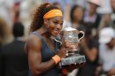 Serena Williams of the U.S. holds the trophy after defeating Russia's Maria Sharapova in two sets 6-4, 6-4, in the women's final of the French Open tennis tournament, at Roland Garros stadium in Paris, Saturday June 8, 2013. (AP Photo/Christophe Ena)