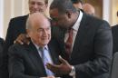 FILE - In this May 23, 2012, file photo, newly elected president of CONCACAF Jeffrey Webb, right, talks to FIFA President Sepp Blatter as they arrive at the meeting of the Confederation of North, Central American and Caribbean Association Football prior to the two-day congress of FIFA in Budapest, Hungary. Webb has been extradited to the United States following his arrest in Switzerland on racketeering and bribery charges filed by American prosecutors. The Swiss Federal Office of Justice said Thursday, July 16, 2015, the man was extradited a day earlier after 50 days of detention. U.S. authorities have said more indictments could follow, and FIFA President Sepp Blatter is a target of the widening case. (Szilard Koszticsak/MTI via AP, File)