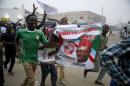 People jubilate along a street after All Progressive Congress candidate Muhammadu Buhari is pronounced the winner of Nigeria's presidential election, in Kano
