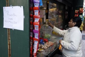 A woman purchase Powerball lottery tickets from a newsstand&nbsp;&hellip;