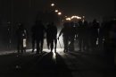 Riot police take up positions as members of the Muslim Brotherhood and supporters of Mursi flee during clashes near a television production complex in Six October City in Giza
