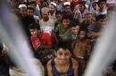 Rohingya people from Myanmar, who were rescued from human traffickers, react in a communal cell at the Songkhla Immigration Detention Centre