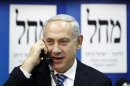 Israel's Prime Minister Netanyahu speaks on the phone to persuade citizens to vote for his party in Tel Aviv