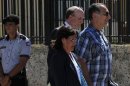 Cuban agent Rene Gonzalez walks next his lawyer outside the U.S Interest Section in Havana