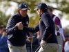 U.S. golfer Bradley celebrates with Mickelson after sinking a birdie putt to win the ninth hole during the morning foursomes round at the 39th Ryder Cup matches at the Medinah Country Club