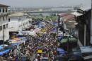 Christmas shoppers flock to a market despite concerns over Ebola in Monrovia