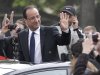 New French President Francois Hollande waves out of a sunroof as he rode up the Champ-Elysses avenue after the presidential handover ceremony, Tuesday, May 15, 2012 in Paris.  Hollande became president of France on Tuesday in a ceremony steeped in tradition, taking over a country with deep debts and worried about Europe's future and pledging to make it a fairer place.  (AP Photo/Michel Euler)