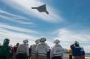 This May 14, 2013 US Navy handout image shows an X-47B Unmanned Combat Air System (UCAS) demonstrator flying over the flight deck of the aircraft carrier USS George H.W. Bush (CVN 77) during operations in the Atlantic Ocean