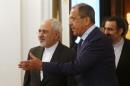 Russian Foreign Minister Lavrov shows way to Iranian Foreign Minister Zarif as they enter hall during their meeting in Moscow