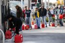 File photo of people standing in line with gas cans at a gas station on Staten Island in New York City after Hurricane Sandy