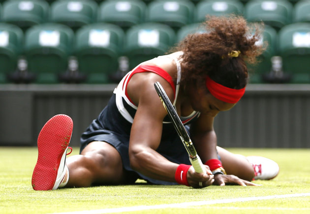 Serena Williams of the United States falls to the court after returning to Jankovic of Serbia in their women&#39;s singles tennis match at the All England Lawn Tennis Club during the London 2012 Olymp