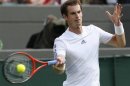 Andy Murray of Britain hits a return to Lu Yen-Hsun of Taiwan in their men's singles tennis match at the Wimbledon Tennis Championships, in London