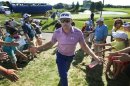 Hunter Mahan of the U.S. greets fans as he walks off the eighteenth green at the Canadian Open golf tournament in Oakville