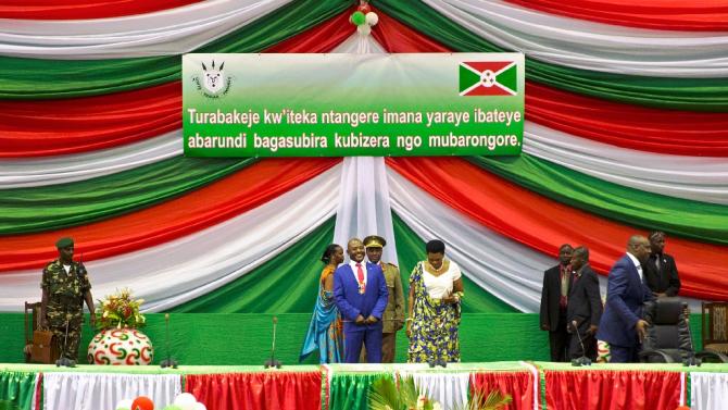 Burundi&#39;s President Pierre Nkurunziza (C) smiles after being sworn in for a controversial third term in power, at the Congress Palace in Kigobe district, Bujumbura on August 20, 2015