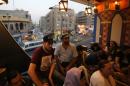 Iraqis watch a concert at the opening of a cafe-cum-bookshop in Baghdad's Karrada Dakhil street