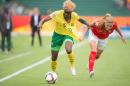 Cameroon's Gaelle Enganamouit (L) and Switzerland's Rachel Rinast vie for the ball during the first half of their FIFA Women's World Cup group C match at Commonwealth Stadium in Edmonton, Canada on June 16, 2015