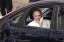 Pope Francis waves as he leaves at the end of a private visit at the Church of the Gesu in Rome