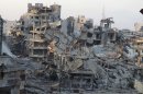 A general view shows damaged buildings on a deserted street in Homs