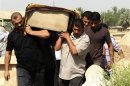 Relatives carry the coffin of a victim killed in one of two bomb attacks in Baquba