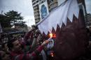 Supporters of Abdel Fattah al-Sisi set fire to a Qatari national flag during a demonstration outside the Qatari embassy in Cairo last year