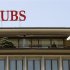 People stand on a terrace of an office building of Swiss bank UBS in Zurich