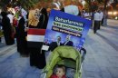 A poster with pictures of Egypt's President Mursi and Turkey's PM Erdogan is attached to a baby stroller during a pro-Islamist demonstration in Istanbul