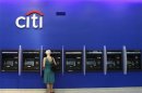 A woman uses an ATM inside a Citi bank branch in New York