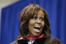 First lady Michelle Obama jokes with a student as she hands out diplomas during the graduation ceremony for Martin Luther King, Jr. Academic Magnet High School on Saturday, May 18, 2013, in Nashville, Tenn. (AP Photo/Mark Humphrey)
