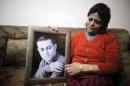 The mother of Muhammad Musallam, an Israeli Arab held by Islamic State in Syria as an alleged spy, weeps as she holds his photograph in her East Jerusalem home