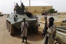 Fighters from the Al Qaeda-linked Islamist group MUJWA stand guard in Gao