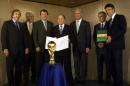 FILE - In this Aug. 10, 1999 file photo Guenter Netzer, Fedor Radmann, Wolfgang Niersbach, FIFA president Sepp Blatter, Franz Beckenbauer, head of the German bid committee, Horst R. Schmidt, secretary general of the German Football Association (DFB) and Michel Zen-Ruffinen, Fifa secretary general, from left, pose during the presentation of the 2006 FIFA World Cup Bid of Germany at the Fifa headquarters in Zurich, Switzerland. (Christoph Ruckstuhl/Keystone via AP, file)